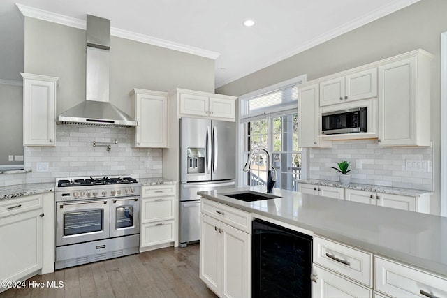 kitchen with white cabinets, appliances with stainless steel finishes, wine cooler, and wall chimney exhaust hood