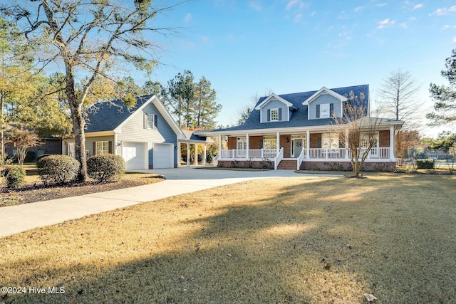 view of front of home featuring an outbuilding, a porch, a garage, and a front lawn