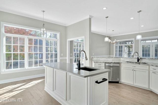 kitchen with sink, stainless steel dishwasher, pendant lighting, white cabinets, and light wood-type flooring