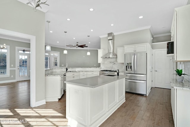 kitchen with white cabinetry, stainless steel appliances, wall chimney range hood, dark hardwood / wood-style flooring, and a center island with sink