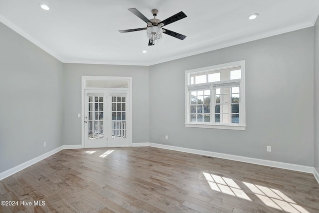 empty room featuring crown molding, french doors, ceiling fan, and light hardwood / wood-style floors