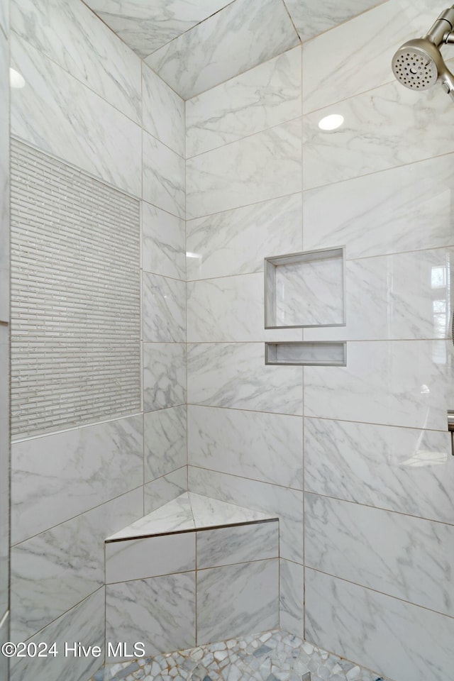 bathroom with tiled shower