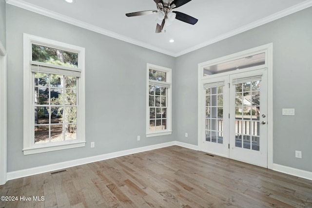 empty room featuring crown molding, hardwood / wood-style floors, and ceiling fan