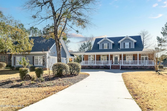 new england style home with a porch and a front yard