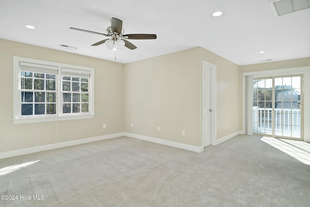 carpeted empty room featuring ceiling fan