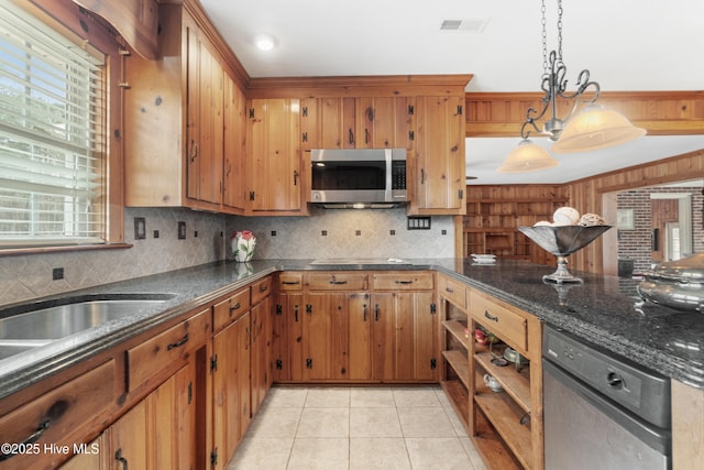 kitchen featuring pendant lighting, backsplash, light tile patterned floors, and black dishwasher