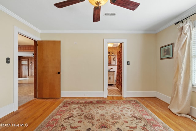 unfurnished bedroom featuring connected bathroom, ceiling fan, light hardwood / wood-style flooring, and ornamental molding