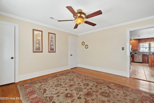 spare room with ceiling fan, light hardwood / wood-style floors, and ornamental molding