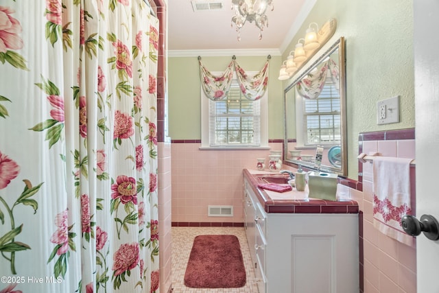 bathroom with vanity, a shower with curtain, crown molding, tile patterned flooring, and tile walls