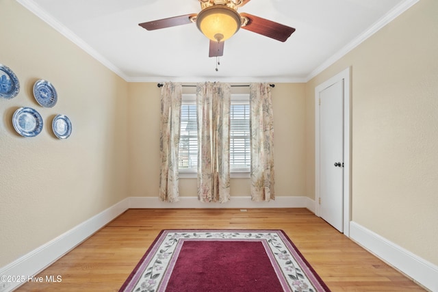 spare room featuring hardwood / wood-style floors, ceiling fan, and ornamental molding