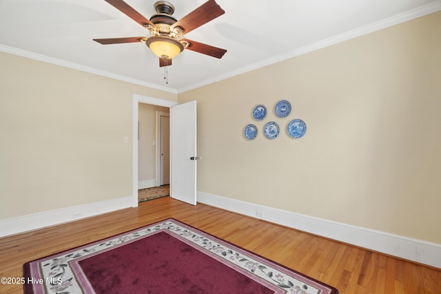 unfurnished room featuring ceiling fan, wood-type flooring, and ornamental molding