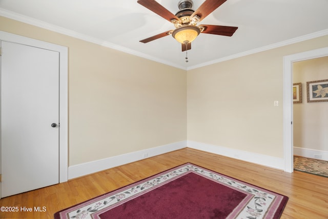 unfurnished room featuring ceiling fan, wood-type flooring, and ornamental molding