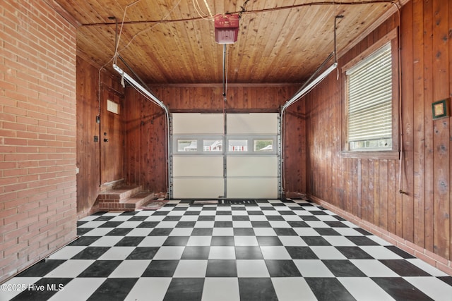 garage featuring wood walls, wooden ceiling, and a garage door opener