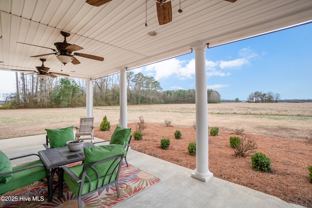 view of patio featuring ceiling fan and a rural view