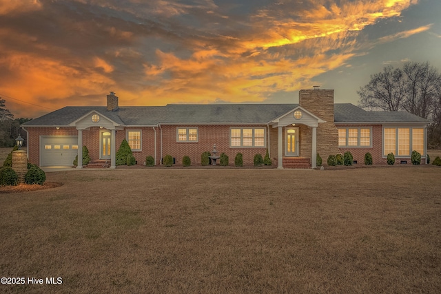 ranch-style house with a lawn and a garage