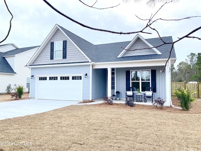 view of front facade featuring a porch and a garage