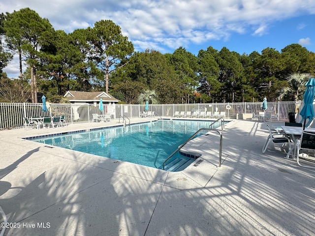 pool featuring fence and a patio