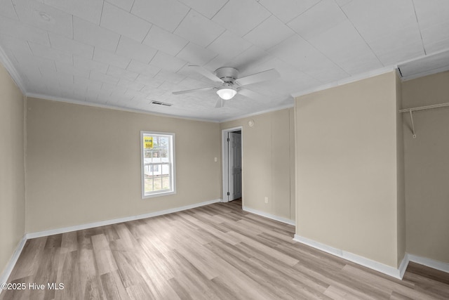 unfurnished bedroom featuring light wood finished floors, baseboards, visible vents, and ornamental molding