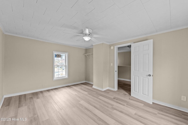 unfurnished bedroom featuring baseboards, ornamental molding, a closet, and light wood-style floors