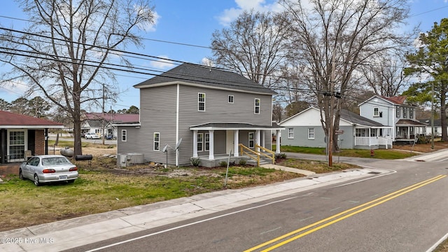 traditional style home featuring a residential view and covered porch