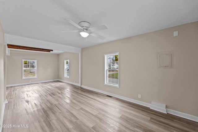 unfurnished living room featuring ceiling fan, visible vents, baseboards, and wood finished floors