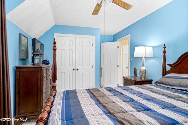 bedroom featuring ceiling fan, lofted ceiling, a textured ceiling, and a closet