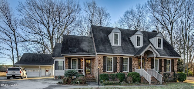 cape cod-style house with a porch and a garage