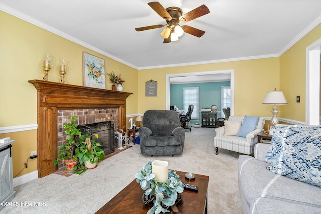 carpeted living room with ceiling fan, crown molding, and a brick fireplace