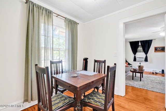 dining room with hardwood / wood-style floors, ceiling fan, and ornamental molding