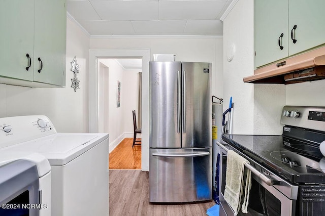 kitchen with light hardwood / wood-style flooring, green cabinetry, washer and clothes dryer, appliances with stainless steel finishes, and ornamental molding