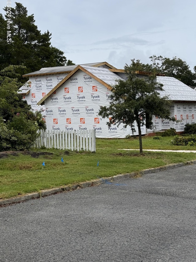 view of property exterior with a yard