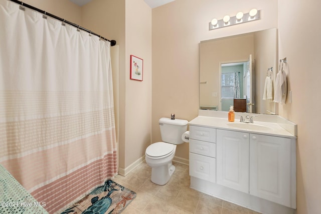 bathroom featuring tile patterned flooring, vanity, and toilet