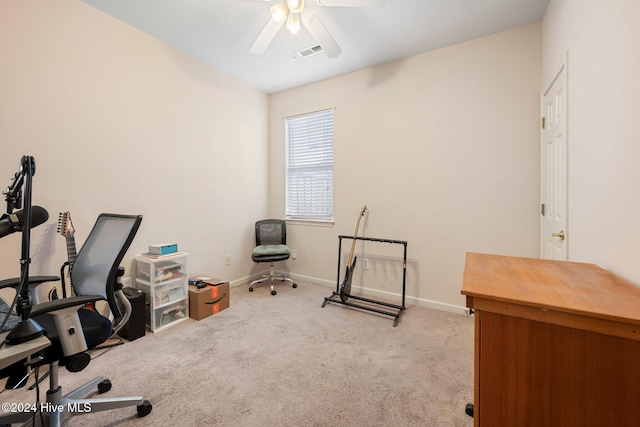 carpeted home office with ceiling fan