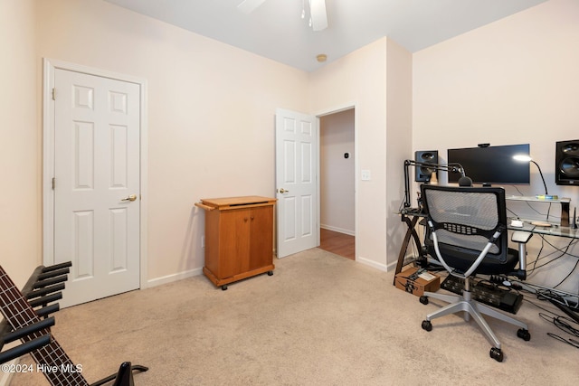 carpeted office featuring ceiling fan