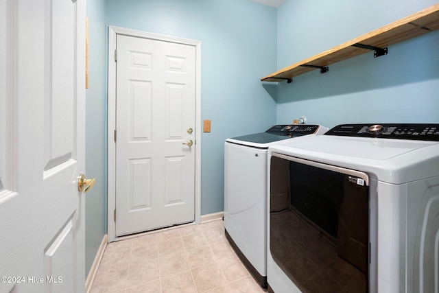 laundry area with light tile patterned flooring and independent washer and dryer