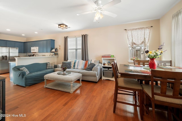 living room featuring ceiling fan and hardwood / wood-style flooring