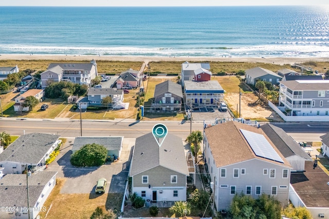drone / aerial view with a residential view, a view of the beach, and a water view