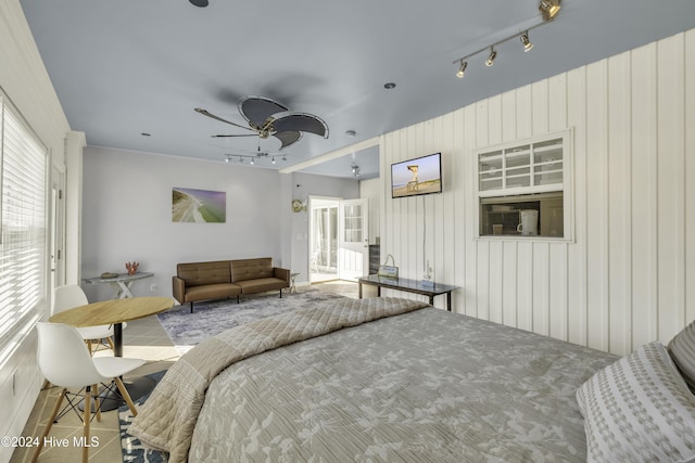 bedroom with track lighting and ceiling fan