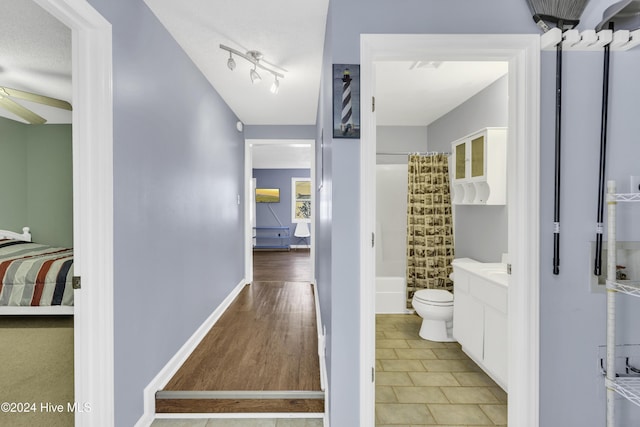 bathroom with vanity, wood finished floors, ceiling fan, shower / tub combo, and toilet