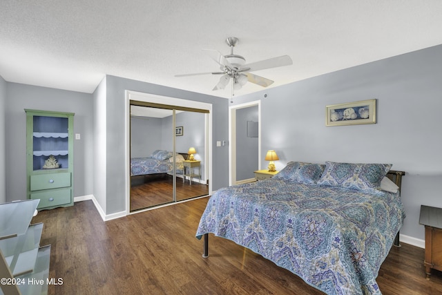bedroom featuring baseboards, wood finished floors, a closet, a textured ceiling, and a ceiling fan