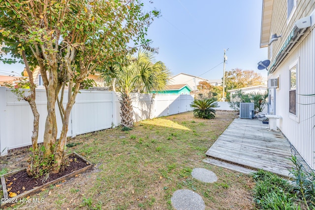 view of yard with a wooden deck and central AC