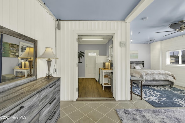 interior space with freestanding refrigerator and a ceiling fan