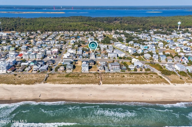 bird's eye view featuring a beach view, a water view, and a residential view
