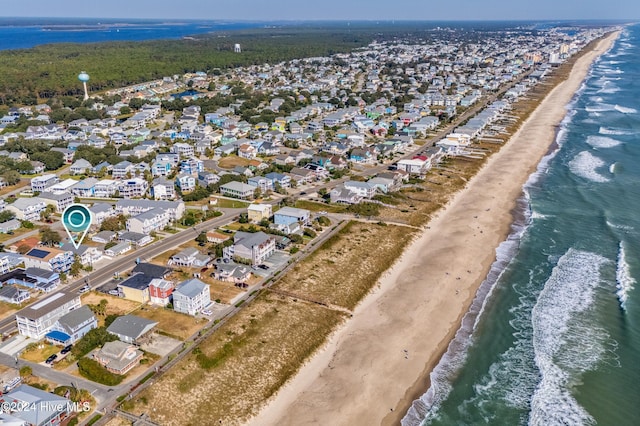 bird's eye view featuring a water view and a beach view