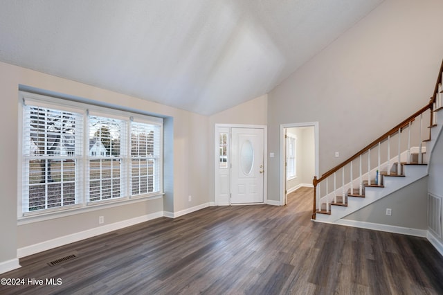 foyer featuring dark hardwood / wood-style flooring and high vaulted ceiling