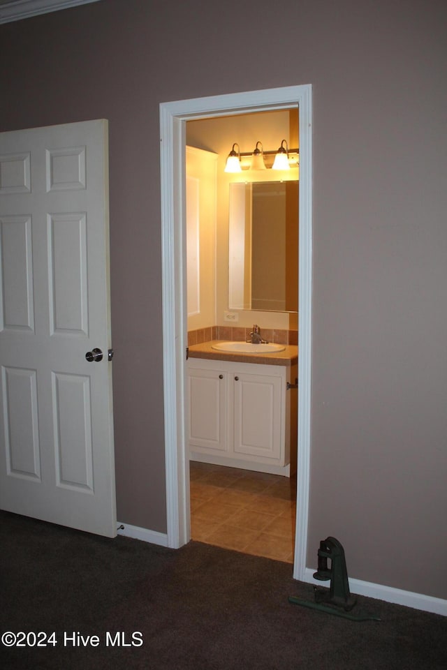 hallway with carpet flooring and sink