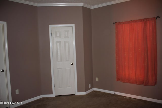 carpeted spare room featuring ornamental molding