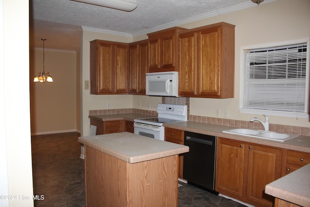 kitchen featuring sink, a center island, a notable chandelier, decorative light fixtures, and white appliances