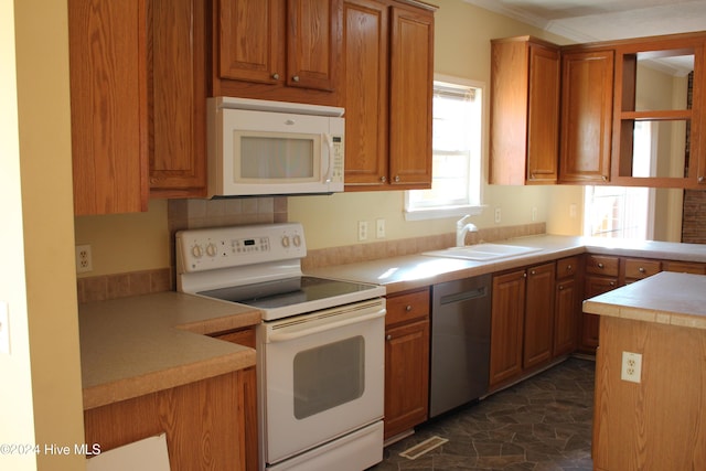 kitchen featuring crown molding, white appliances, and sink