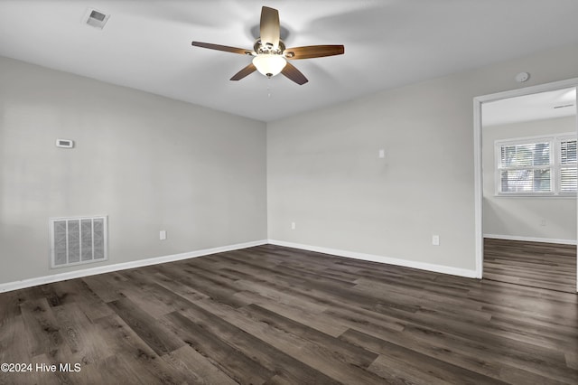 empty room featuring ceiling fan and dark hardwood / wood-style flooring